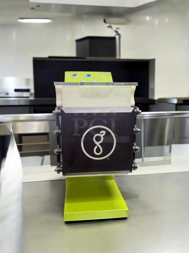Goodnature CT7 cold press juicer in excellent condition, 115V, fully tested, green base, visible control buttons, in a kitchen setting.