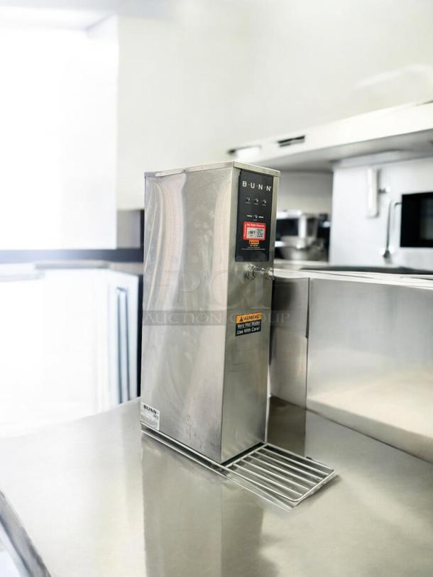 BUNN H5X-4-29-212F hot water dispenser in excellent condition, fully tested, 208V, stainless steel finish, warning labels visible.