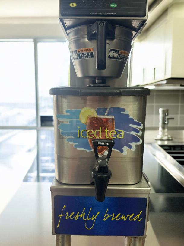 Curtis Commercial Iced Tea Brewer with Dispenser, excellent condition, tested 120V, "iced tea" graphic, "freshly brewed" label.