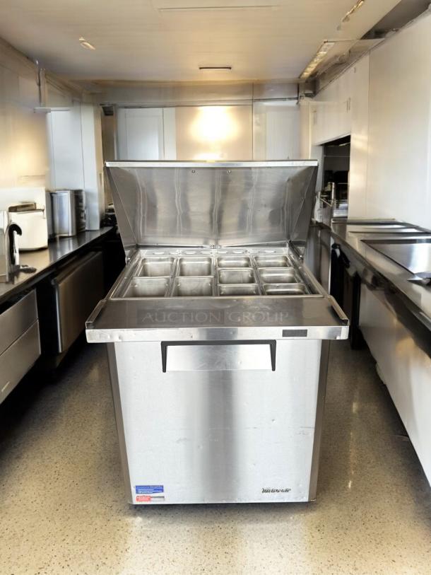 Turbo Air MST-28-12-N prep table in excellent condition, stainless steel, 115V, with multiple compartments, fully tested.
