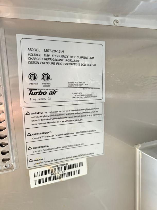Turbo Air MST-28-12-N info label showing model, voltage 115V, and refrigerant details. In excellent condition, fully tested.