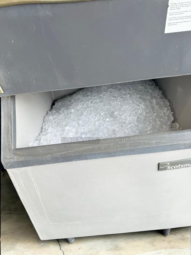 Scotsman Commercial Ice Machine with Bin, excellent condition, 208V, fully tested, filled with ice, visible logo.
