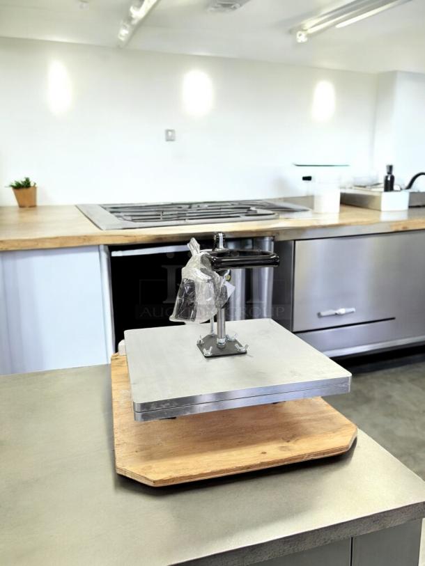 DoughXpress manual pizza dough press in excellent condition, fully tested and working, on a kitchen countertop.