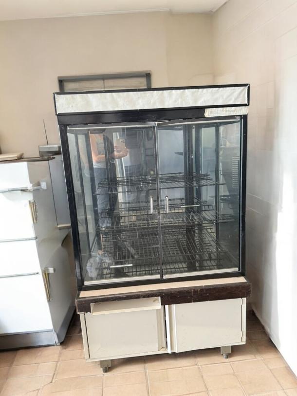 Commercial Grade double-door glass display merchandiser in excellent condition, fully tested and working, with adjustable shelves.