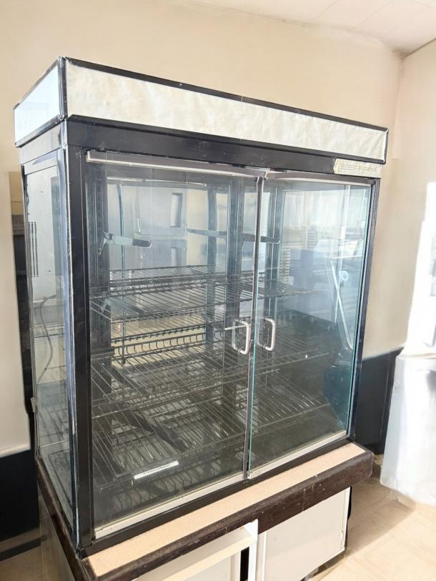 Commercial Grade glass display merchandiser, double door, excellent condition, fully tested, metal racks, clear glass.