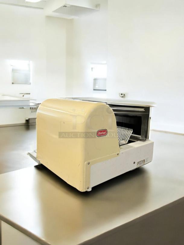 Berkel MB 1/2 Bread Slicer in excellent condition, 115V, fully tested, beige finish, visible brand logo, in commercial kitchen.