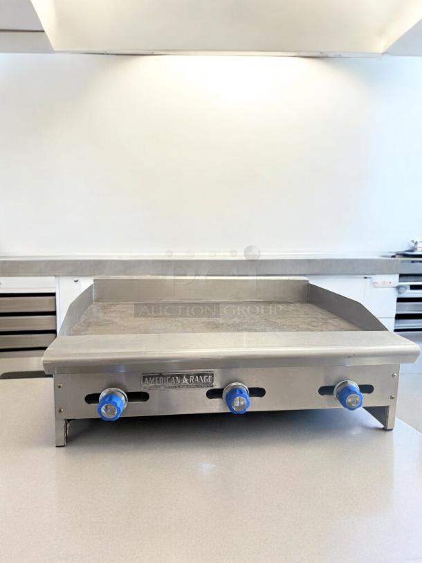 American Range 36" Heavy-Duty Gas Griddle, excellent condition, tested and working, with blue control knobs, natural gas.