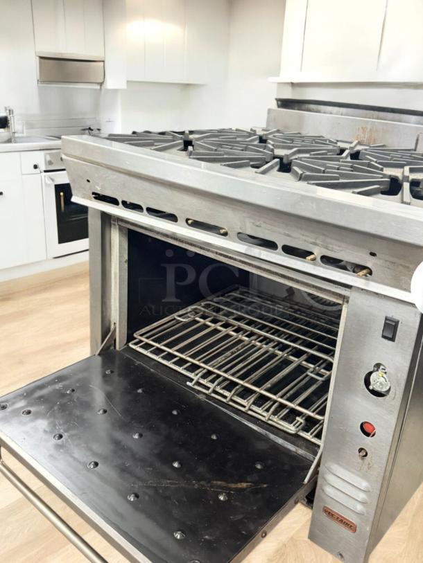 Montague 6-burner gas range with oven, excellent condition, natural gas, fully tested, stainless steel, open oven door.