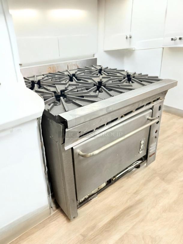 Montague 6-Burner Gas Range w/ Oven in excellent condition, natural gas, fully tested and working, stainless steel finish.