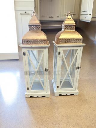 Pair of Moroccan-style lanterns in excellent condition, featuring white wood frames and ornate gold metal tops.