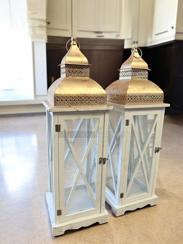 Pair of Moroccan-style lanterns with white wood frame and gold metal top, excellent condition, inspected and ready for use.