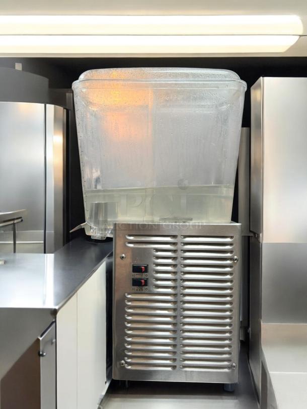Crathco D25-3 beverage dispenser, excellent condition, 115V, fully tested, visible controls, clear tank, stainless steel base.