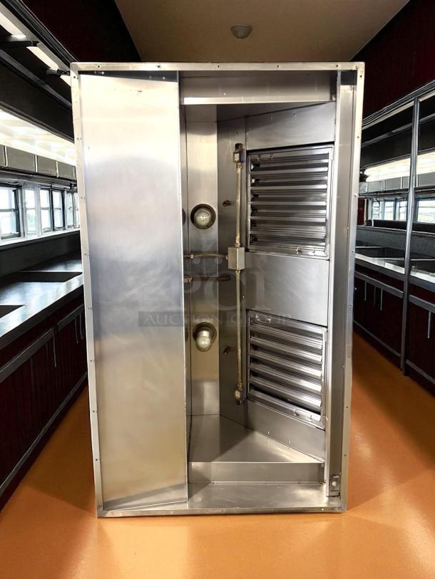 Excellent condition stainless steel hood system, like new, with louver design and integrated light fixture, suitable for commercial use.