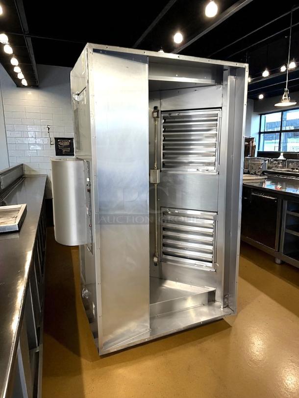 Stainless steel hood system in excellent condition, featuring sleek design and ventilation louvers, appears like new.