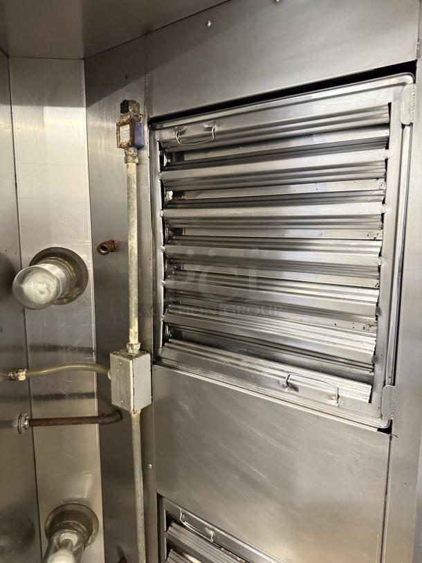 Alt text: Stainless steel hood system in excellent condition, featuring sleek vent panels and sturdy construction, like new.