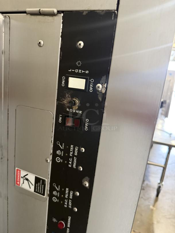 Commercial hood system panel, excellent condition, stainless steel, control switches, labeled "E.A.C. Filter" and "Lights."