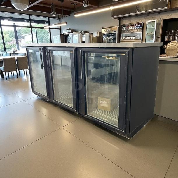 True TBB-4G-HC-LD 90 3/8" black glass door back bar refrigerator with LED lighting, excellent condition, fully tested.