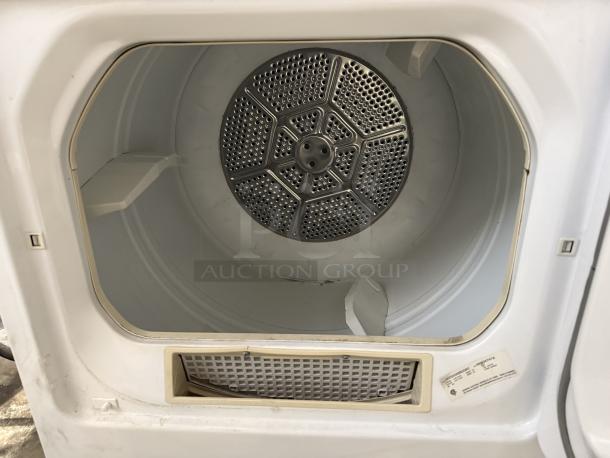 GE Model DCCD330EDWC 7.0 Cu. Ft. coin-operated electric dryer in excellent condition. Interior and control label visible.