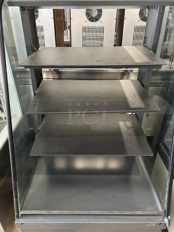 Structural Concepts dry display case in excellent condition, four shelves, glass panels, tested and working, ideal for retail.