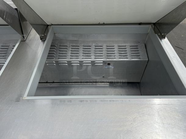 Like new Continental SW60N24M 60" sandwich/salad prep table with refrigerated base, tested and working, 115v, metal interior.