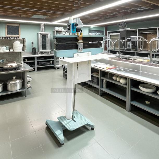 ULINE H-89 foot-operated impulse sealer, 18-inch, fully tested, working condition, metallic stand, in commercial kitchen.