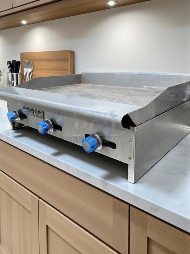 American Range 36" gas griddle in excellent condition, brushed steel, three blue control knobs, tested and working.