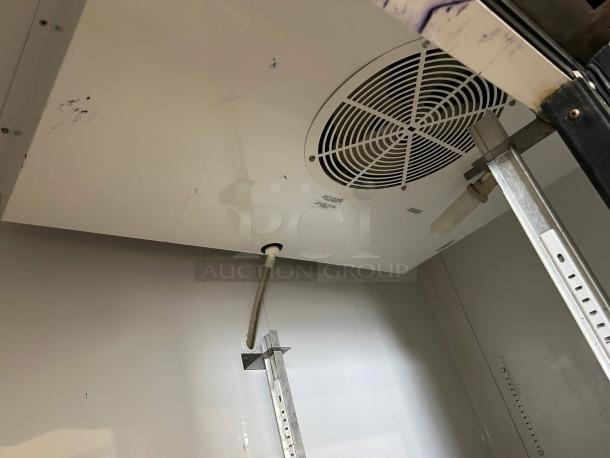 Interior view of True T-49-HC refrigerator, showing shelf brackets and fan. Good condition, well-maintained, 54" wide.