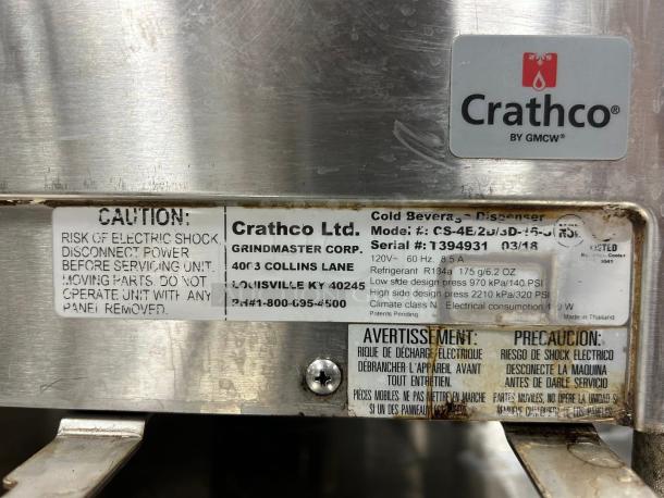 Crathco CS-4E-2/3D-16 beverage dispenser label showing caution, model, and specifications. Visible wear.