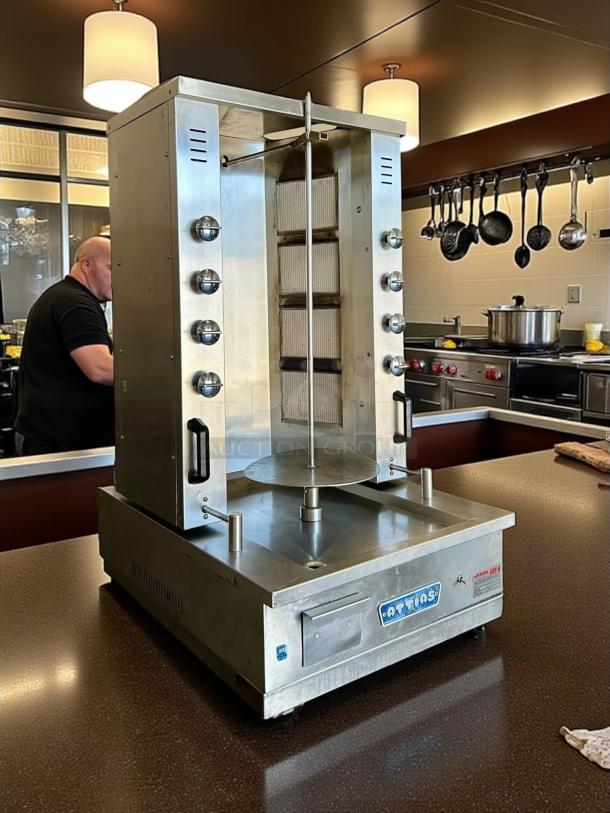 Attias GRY-8 8 Burner Electric Gyro Machine, 100lbs capacity, stainless steel, tested working, with brand labeling on base.