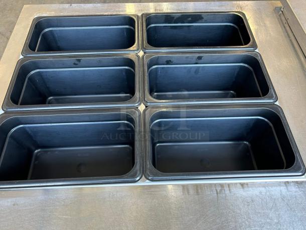 Continental SW60-24M commercial refrigerator freezer with dual lid top access. Six compartments visible. Excellent condition.