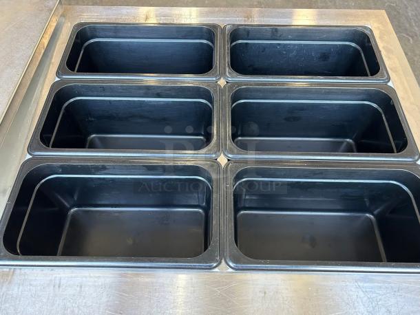 Continental SW60-24M commercial refrigerator freezer with dual lid top access, six compartments visible, 115V, outstanding condition.