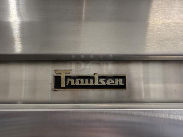 Traulsen RLT332WUT-FHS logo on stainless steel reach-in freezer, showcasing brand authenticity and durability.