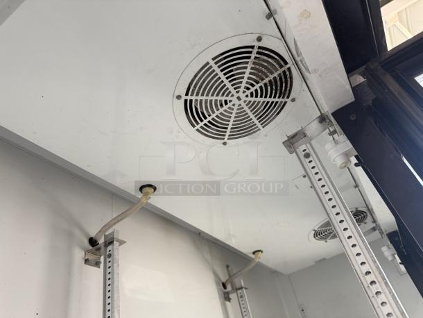 True Manufacturing GDM-72 glass door merchandiser interior, showing ducts and wiring. In great condition, tested, working.