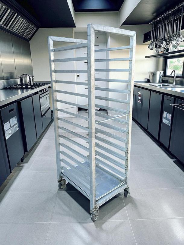 Alexander Industries bakery speed rack, metal construction, visible wear, tested and working, 12 shelves, on casters.