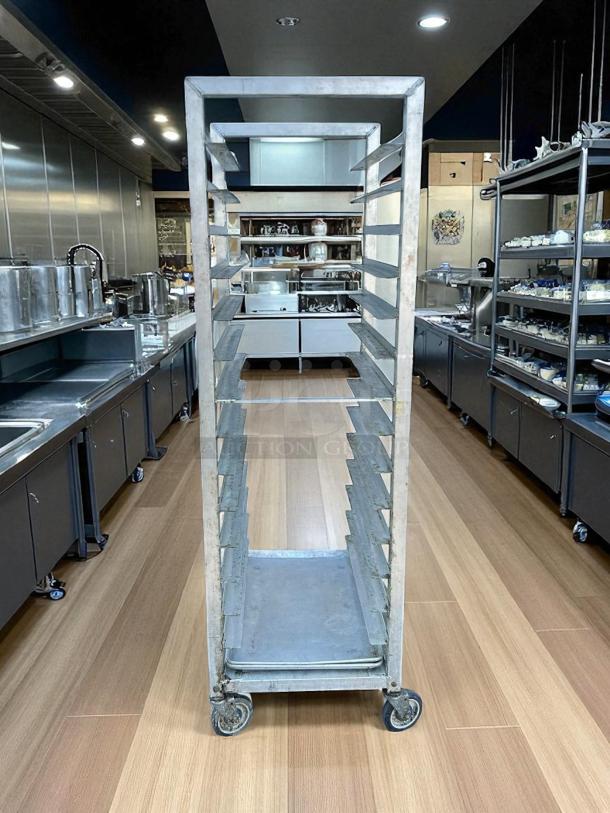 Alexander Industries bakery speed rack, metal, tested and working, multiple shelves, on casters, used in commercial kitchen.