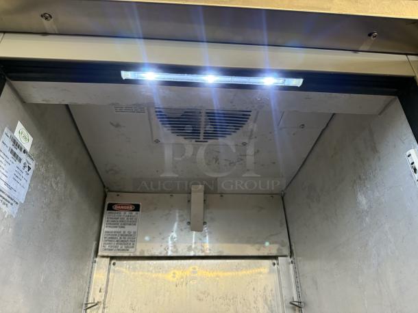 Economy Series EF1A-FS Reach-in Freezer, one door, tested and working, visible labels with safety and model details.