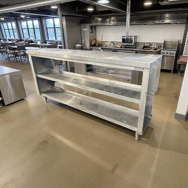 Custom 73" stainless steel table with shelves, sturdy construction, excellent condition, ideal for commercial kitchen use.