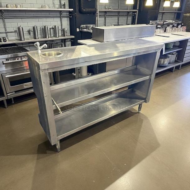 All stainless steel 52" custom table with hand washing station, sturdy construction, two shelves, excellent condition.