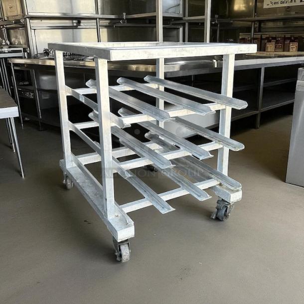 Great condition New Age half-size mobile aluminum can rack for #10 and #5 cans, on wheels.