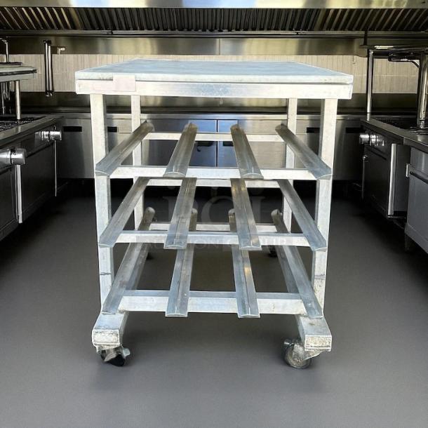 New Age aluminum mobile can rack, half size, for #10 and #5 cans. Great condition, on caster wheels, sturdy shelves.