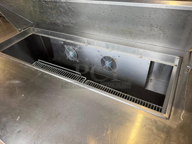 Atosa MSF8302 48" two-door salad prep table refrigerator in excellent condition, showcasing interior storage and fan.