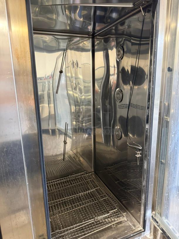 Electrolux AOS202GTP1 electric combi oven interior showing test probes and shelves, in working condition.
