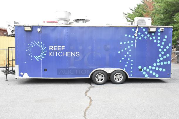 Blue food trailer with "REEF KITCHENS" logo, equipped with a grease hood, fryers, coolers, freezers, prep tables, and a range. Sold with clear title.