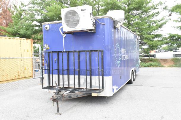 Blue former Popeyes food trailer with refrigeration unit, "REEF KITCHENS" logo, ready for service.