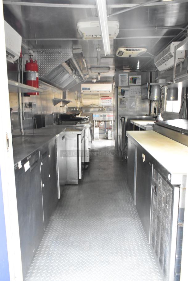 Fully outfitted former Popeyes food trailer with grease hood, Henny Penny fryer, coolers, freezers, prep tables, range.