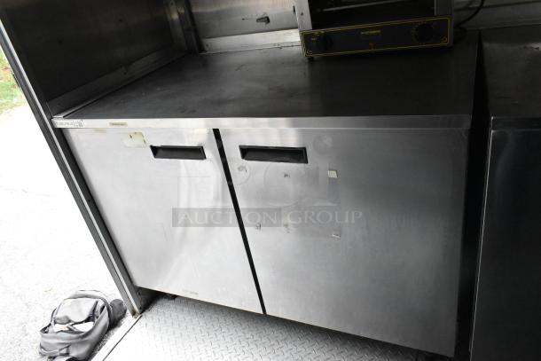 Mobile kitchen with stainless steel prep tables and appliances. Features Henny Penny fryer, coolers, freezers. Clear title.