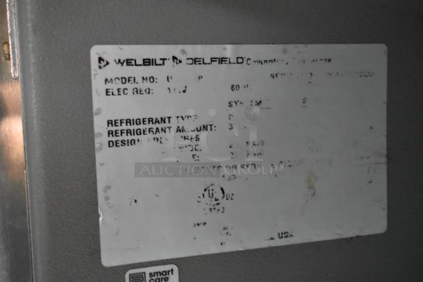 Welbilt Delfield equipment label on a food trailer appliance, showing model and electrical specifications.