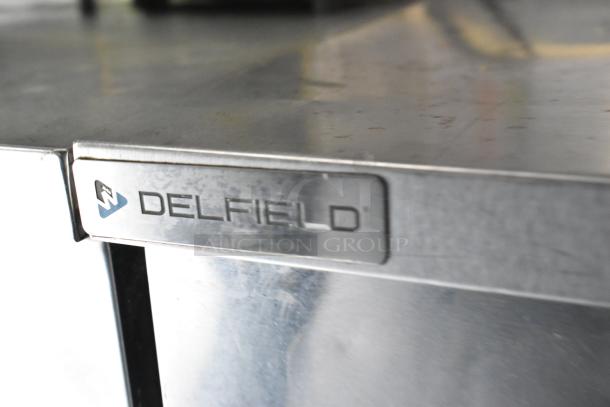 Delfield stainless steel cooler surface, visible brand label. Ideal for mobile kitchen use.
