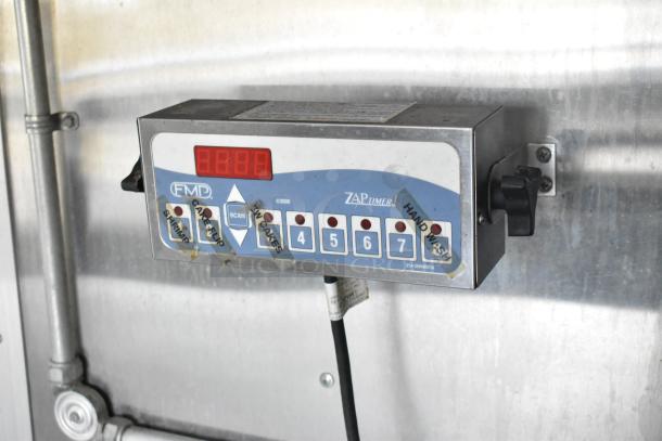 Timer control panel inside a mobile kitchen featuring multiple labeled buttons and a digital display.