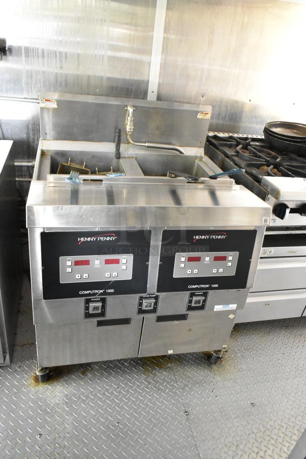 Henny Penny 2-bay fryer in former Popeyes mobile kitchen trailer with grease hood, coolers, and range.
